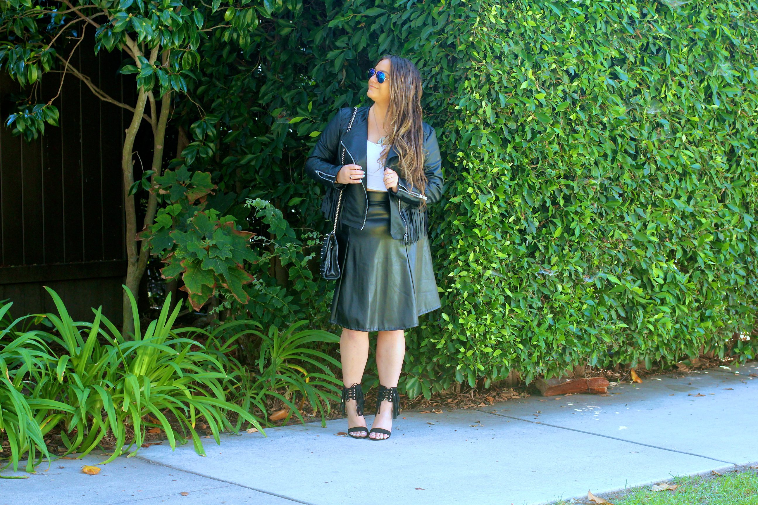 missyonmadison, melissa tierney, fringe leather jacket, coffee shop coats, leather fringe coffee shop coats, ray bans, mirror aviators, black quilted bag, rebecca minkoff affair bag, black rebecca minkoff affair bag, black fringe heeled sandals, black fringe heels, fringe heels, white crop top, black leather midi skirt, black midi skirt, faux leather skirt, holiday style, outfit inspo, ootd, holiday outfit inspo, thanksgiving outfit, fringe trend, how to wear fringe, style blogger,