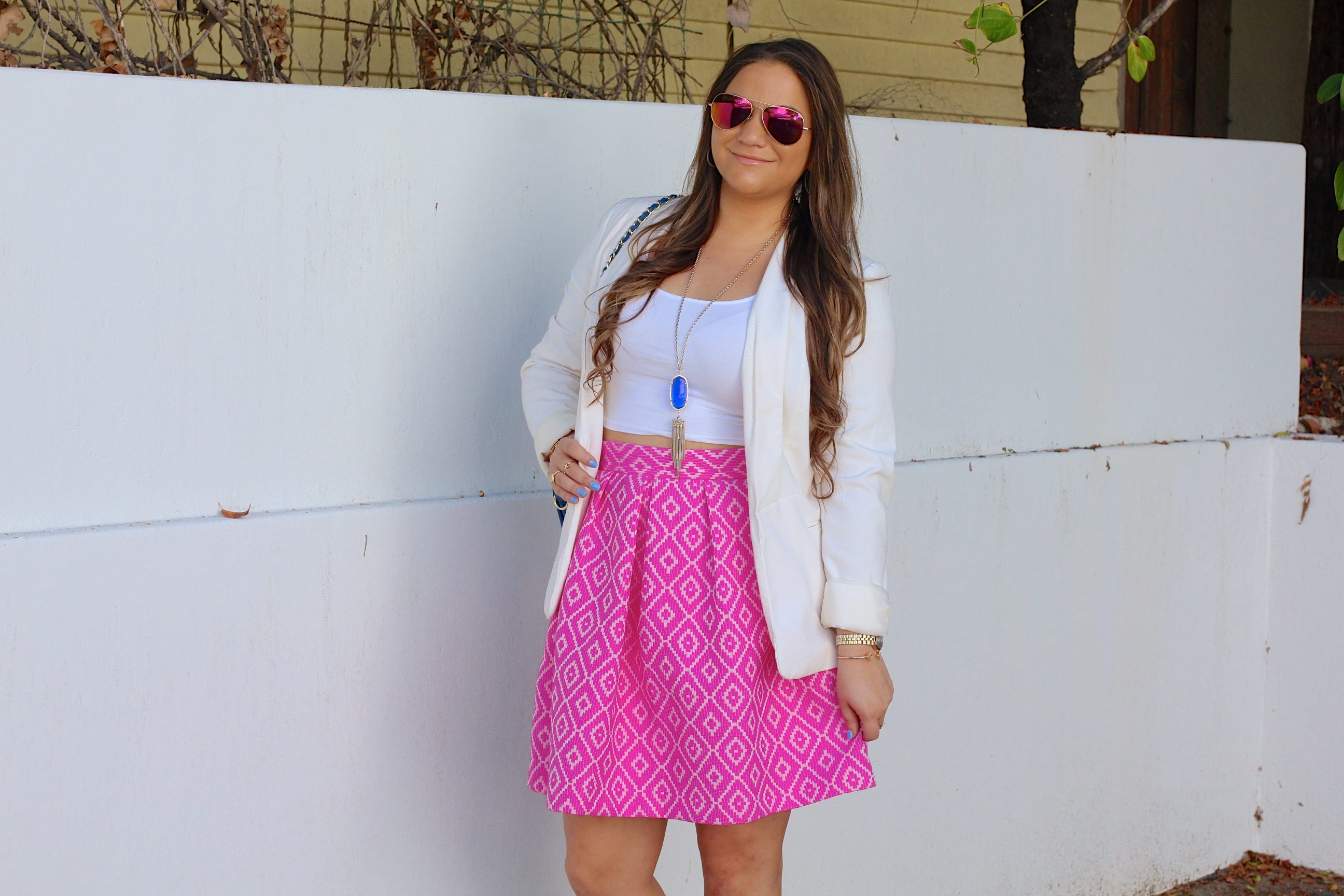 missyonmadison, melissa tierney, hutch design, pink midi skirt, pink printed skirt, white crop top, white boyfriend blazer, white blazer, ray bans, pink aviators, pink ray bans, kendra scott, kendra scott rayne necklace, blue quilted bag, cobalt quilted bag, cobalt bag, gray pumps, gray pointed toe pumps, brunette hair, la blogger, fall style, ootd, outfit inspo, street style, pop of color, colorful outfits, midi skirt, statement piece,