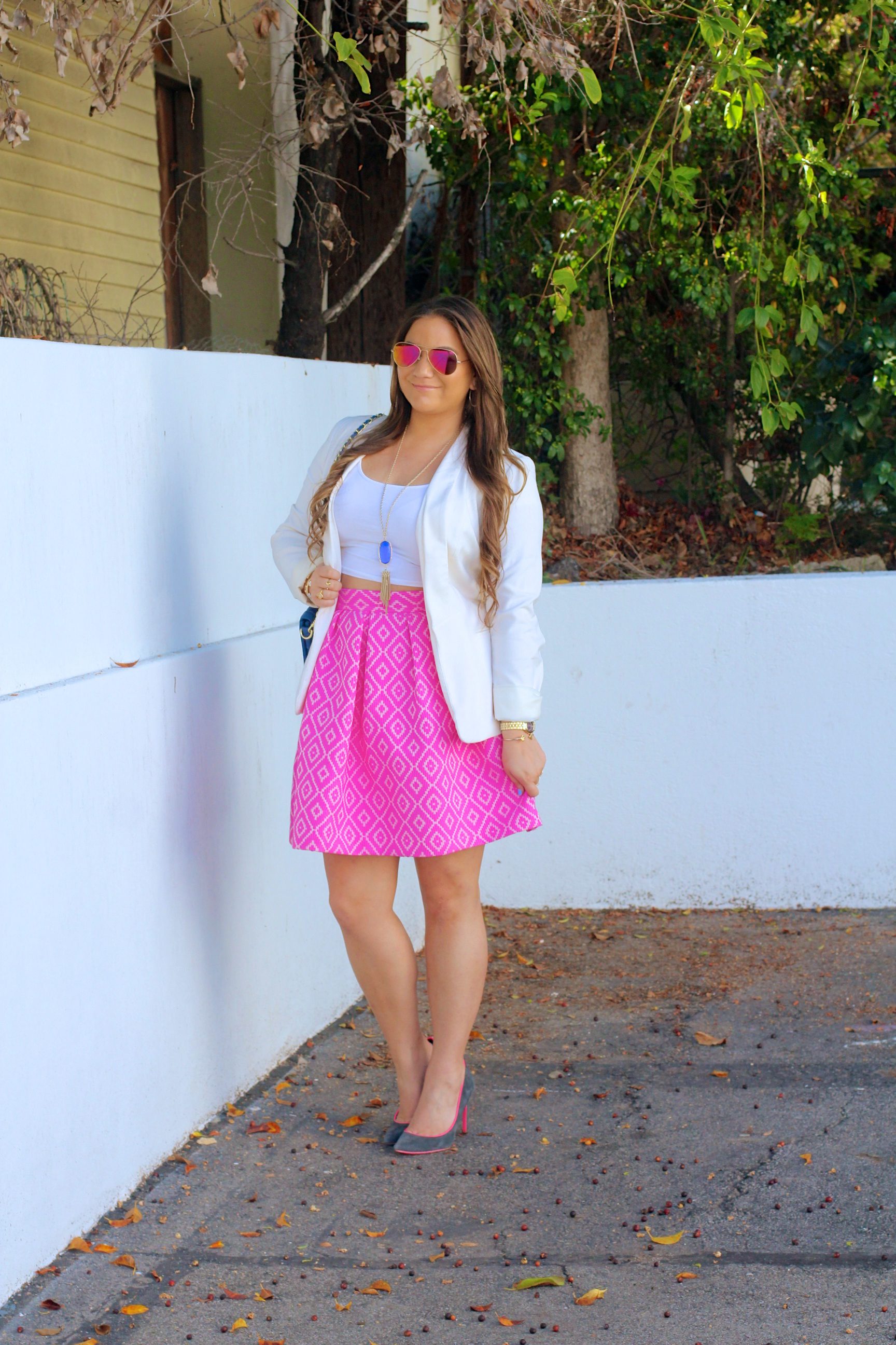 missyonmadison, melissa tierney, hutch design, pink midi skirt, pink printed skirt, white crop top, white boyfriend blazer, white blazer, ray bans, pink aviators, pink ray bans, kendra scott, kendra scott rayne necklace, blue quilted bag, cobalt quilted bag, cobalt bag, gray pumps, gray pointed toe pumps, brunette hair, la blogger, fall style, ootd, outfit inspo, street style, pop of color, colorful outfits, midi skirt, statement piece,