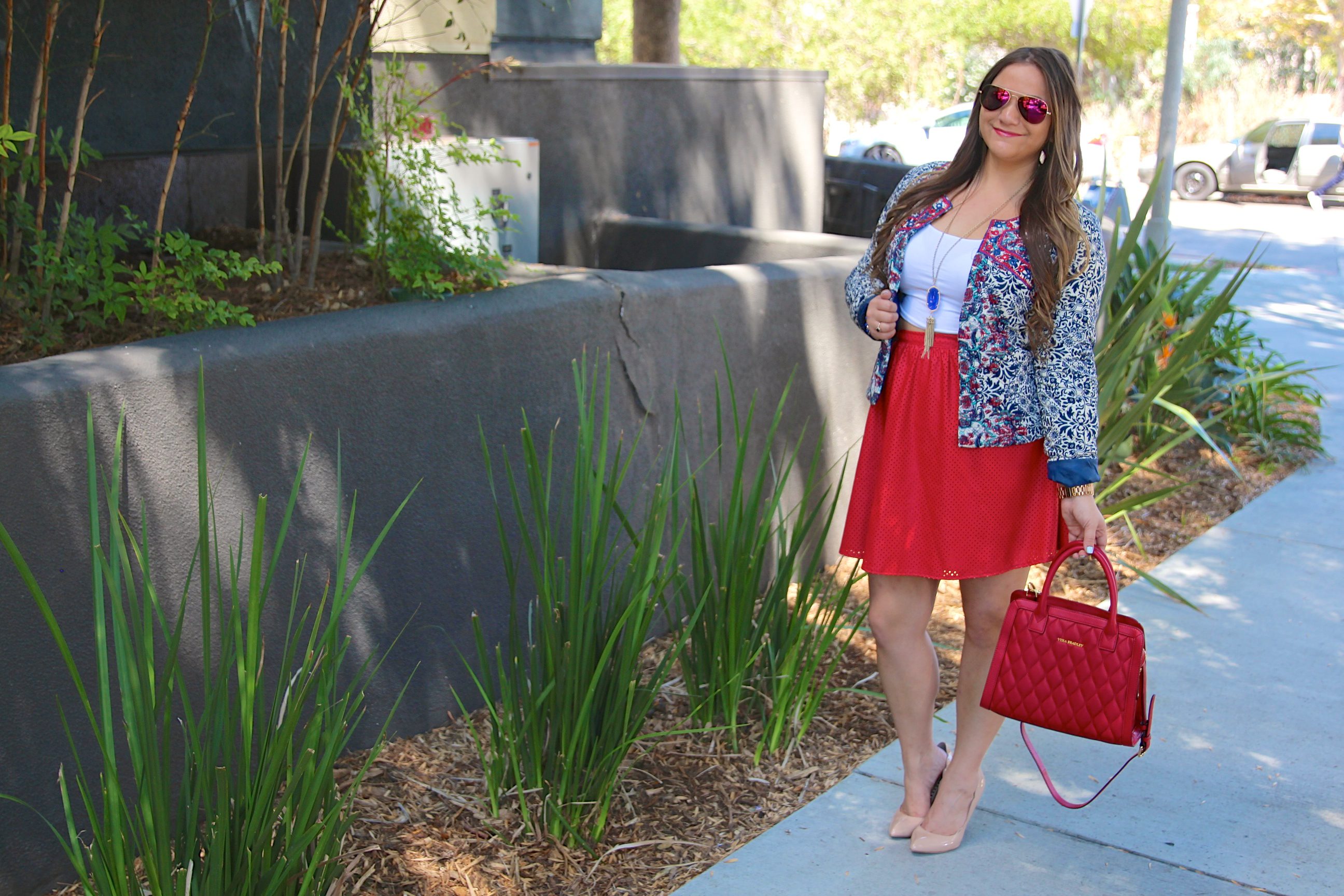 missyonmadison, melissa tierney, shabby apple, shabby apple jacket, embroidered jacket, cropped jacket, cropped printed blazer, red faux leather skirt, red a line skirt, nude pumps, steve madden pumps, nude pointed toe pumps, vera bradley, red vera bradley satchel, kendra scott rayne necklace, kendra scott necklace, white crop top, go jane crop top, ray bans, red mirrored aviators, red sunglasses, printed cropped jacket, brunette hairstyle, curled hair, red skirt, holiday style, fashion blogger, outfit inspo, ootd, fashion blogger, la blogger, vera bradley style,
