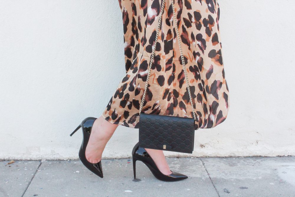 missyonmadison, missyonmadison blog, missyonmadison instagram, leopard print for spring, styling leopard print, la blogger, spring outfit ideas, black patent leather pumps, leopard wrap skirt, leopard skirt, outfit ideas, leopard trend, gucci mini bag, gucci chain on wallet, black ruffle bodysuit, black off the shoulder bodysuit, gucci pearl belt, gucci belt, shein, shein leopard skirt, ootd, style inspo, spring style ideas,